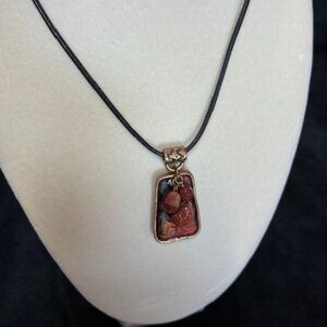 Chico's necklace - black leather strand with orange & gold charm.